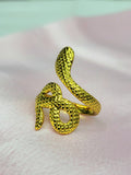 Elowen adjustable anti-tarnish gold plated stainless steel snake ring highlighting an intricate textured scale pattern on a soft pink background.